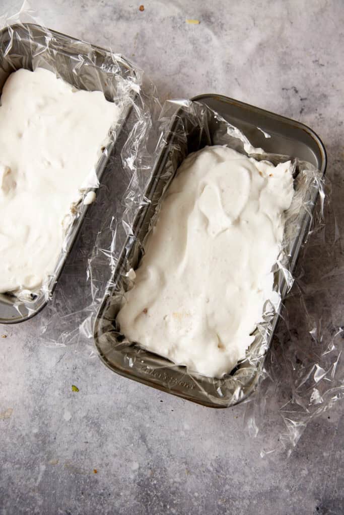 Two loaf pans with the cream mixture.