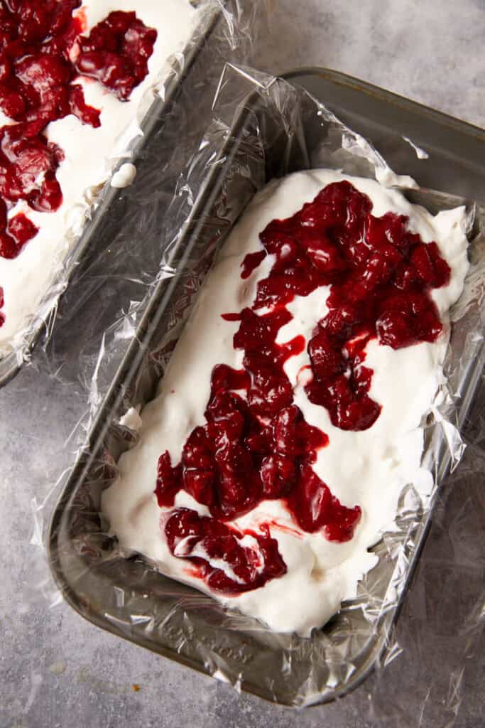A layer of strawberry jam on top of the cream mixture.