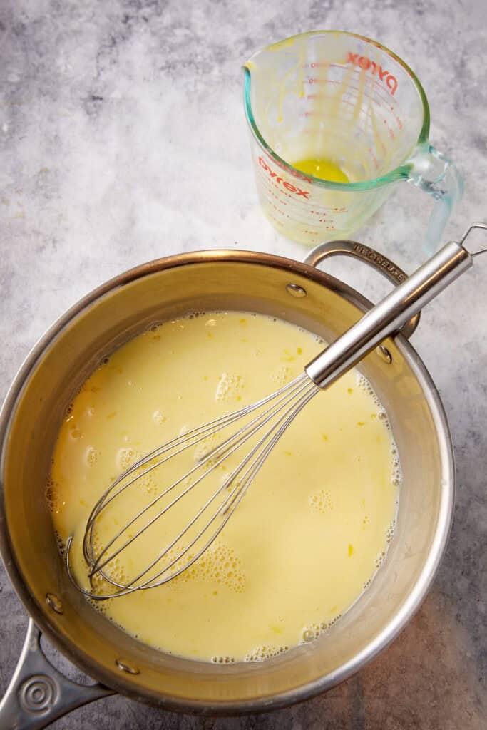 Custard with egg yolks added in a saucepan.