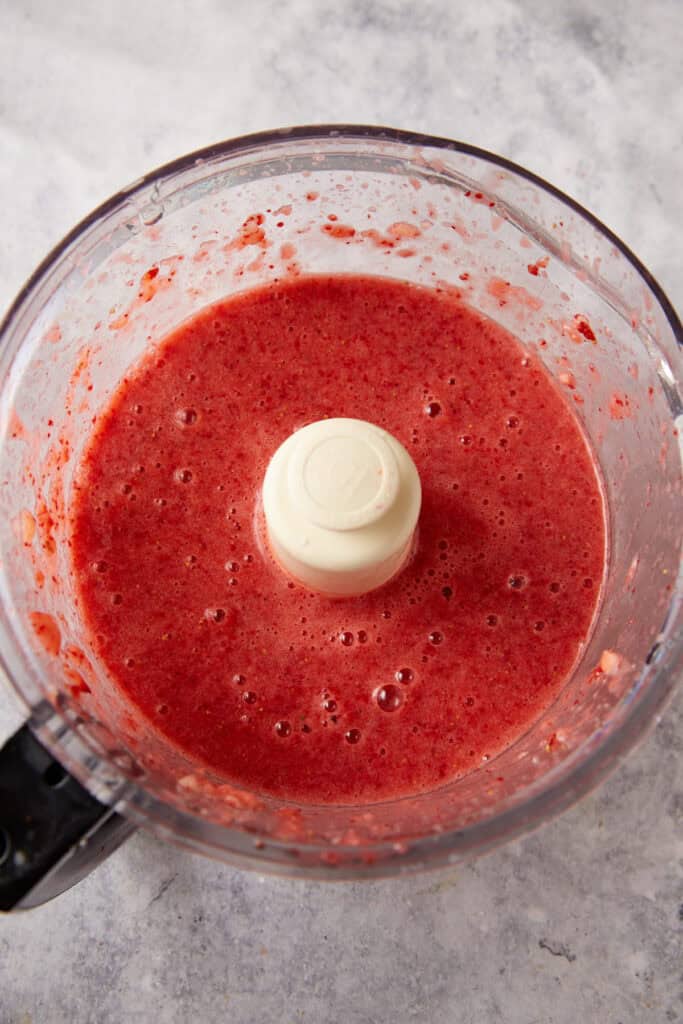 Strawberries pureed in a food processor.