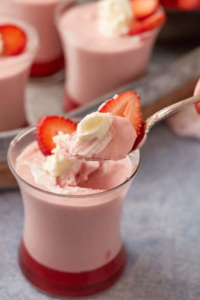 A spoon full of strawberry mousse.