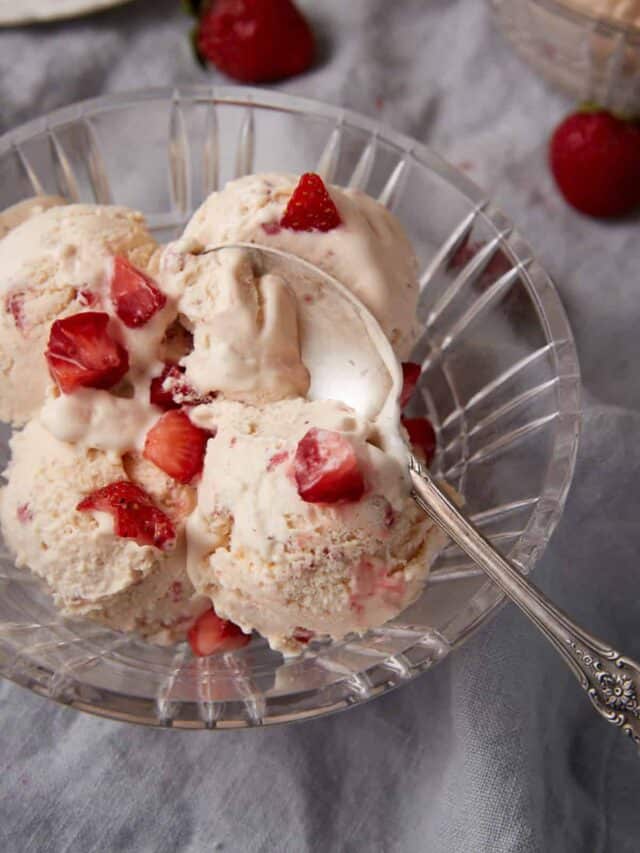A bowl of strawberry ice cream with a spoon.