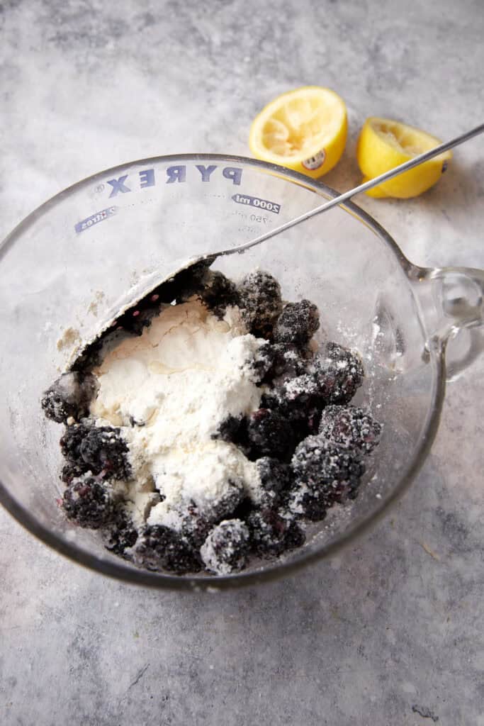Flour, sugar and lemon juice on blackberries.