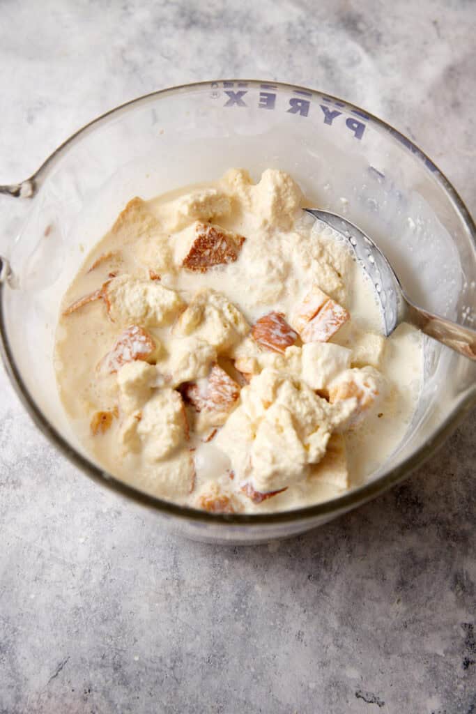Custard poured over bread cubes.