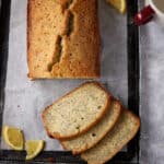 A sliced loaf of lemon poppy seed cake.