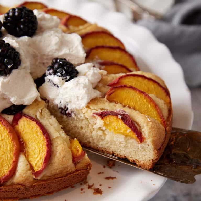 close up of peach blackberry cake being served
