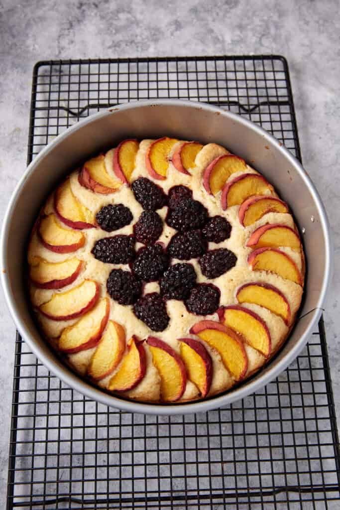 A baked peach buckle in a springform pan.