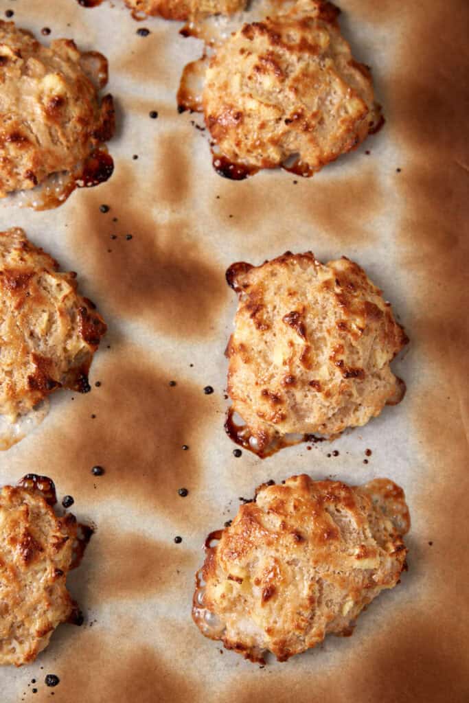 Baked apple fritters on parchment paper.