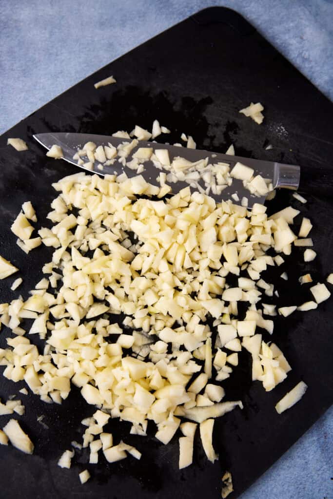 Chopped apples on a cutting board.