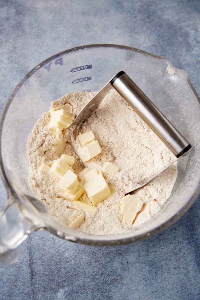 Chunks of butter on top of the flour mixture.