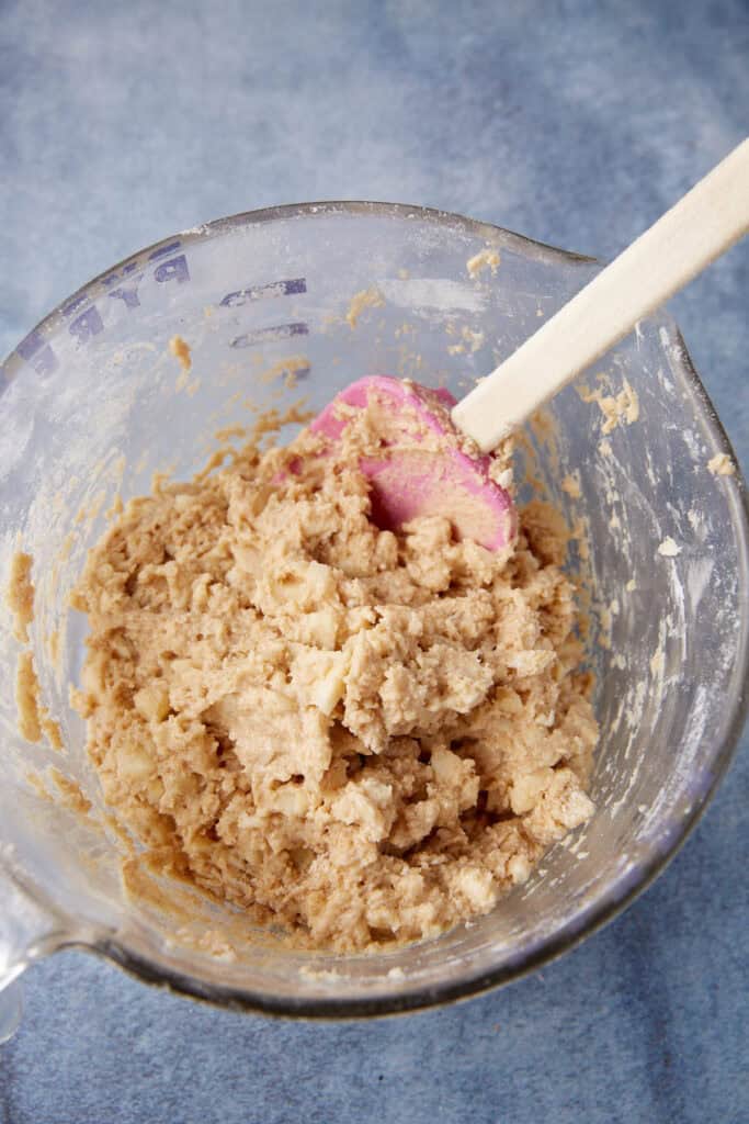 The dough for apple fritters in a bowl.
