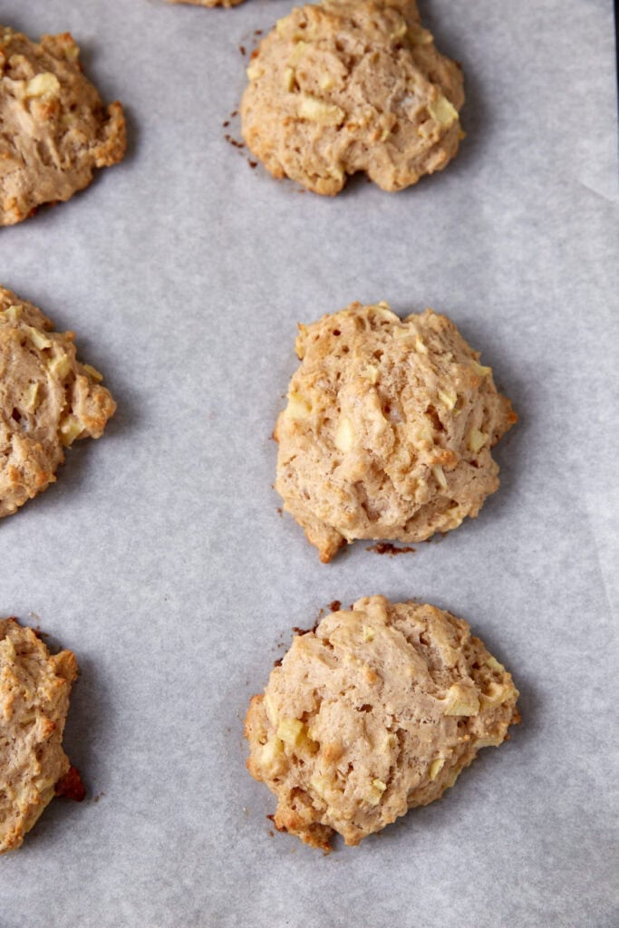 Apple fritter dough on a baking sheet.