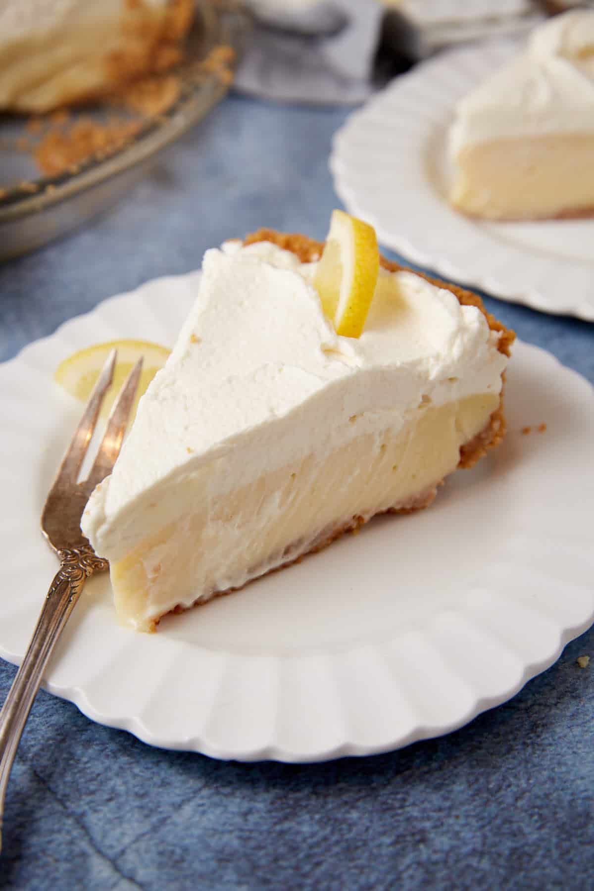 A single slice of lemon pie with a fork.