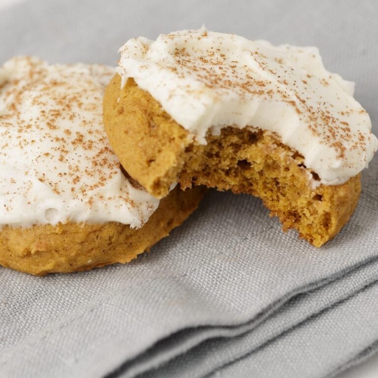 Two pumpkin frosted cookies.