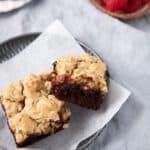 Chocolate brownie bars on parchment paper.
