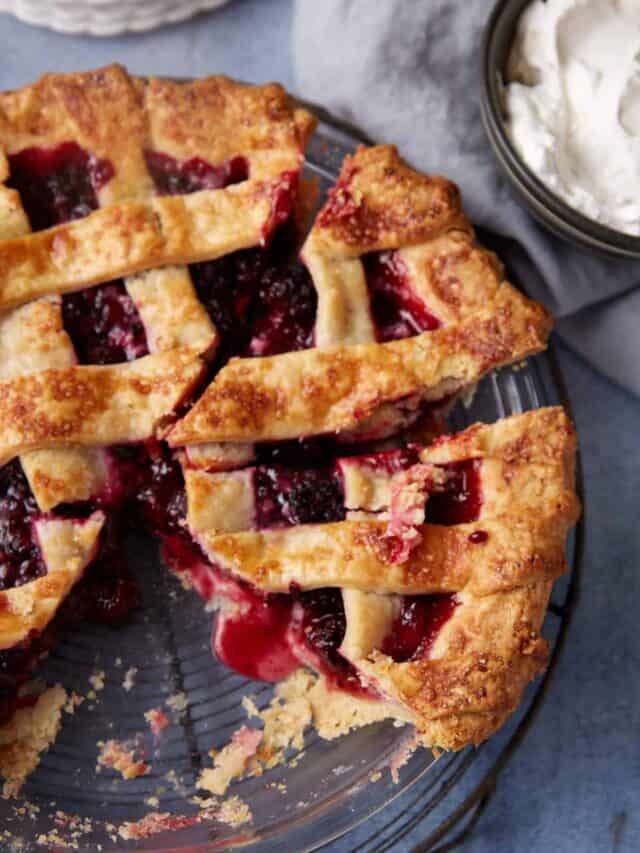 A sliced double crust blackberry pie in a pie dish.