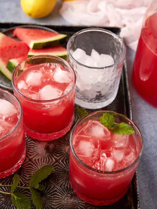 A tray of glasses with watermelon lemonade.