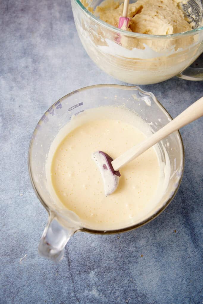 Eggs and sugar beaten in a bowl.