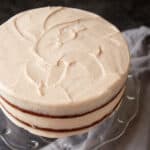 A cake covered with cinnamon cream cheese frosting.