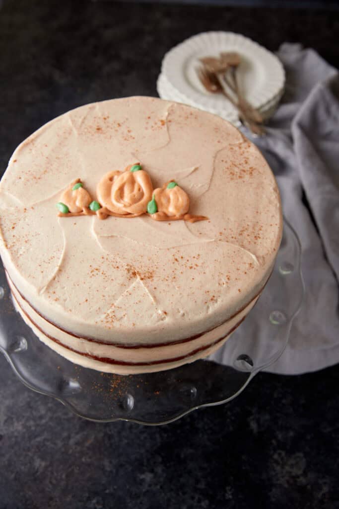 The top of a cake decorated with pumpkins.