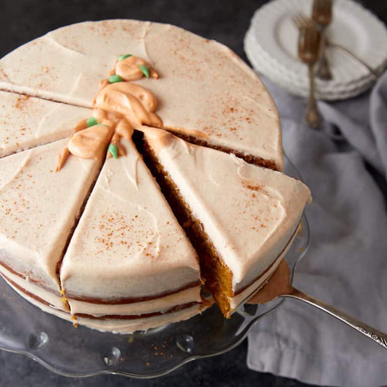 A slice of pumpkin cake being removed from the cake.