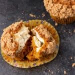 A cream cheese filled pumpkin muffin split in two.