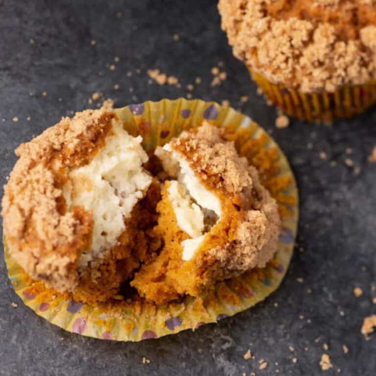 A cream cheese filled pumpkin muffin split in two.