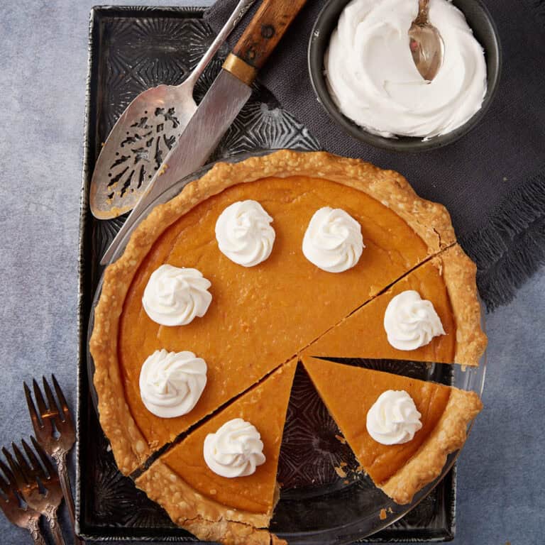A sweet potato pie with a slice removed.