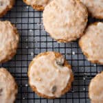 Iced oatmeal cookies on a wire rack.