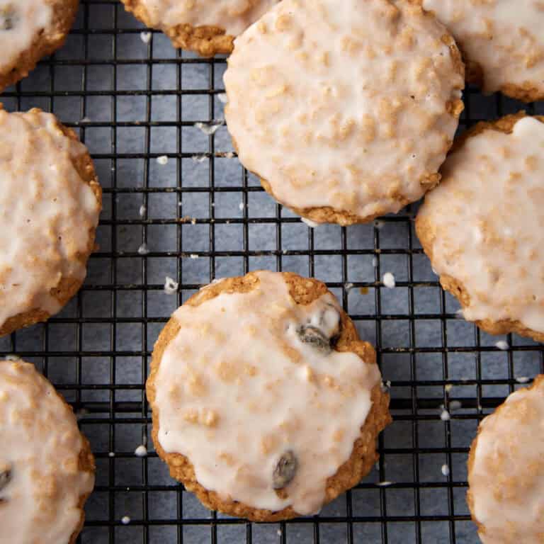 Iced oatmeal cookies on a wire rack.