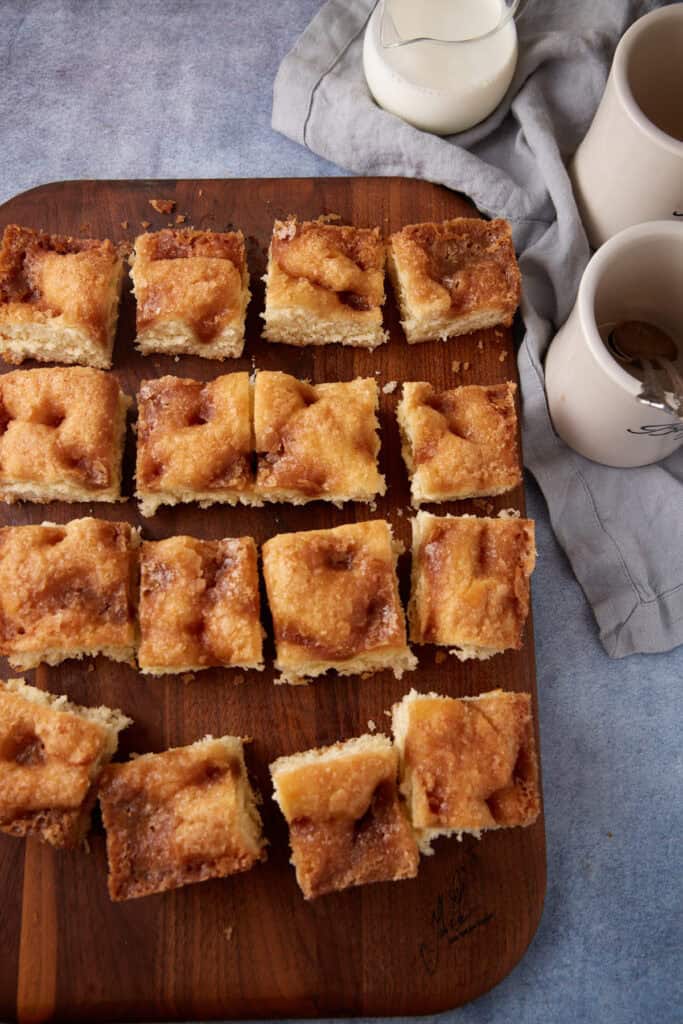 A cut sugar cake wtih coffee cakes.