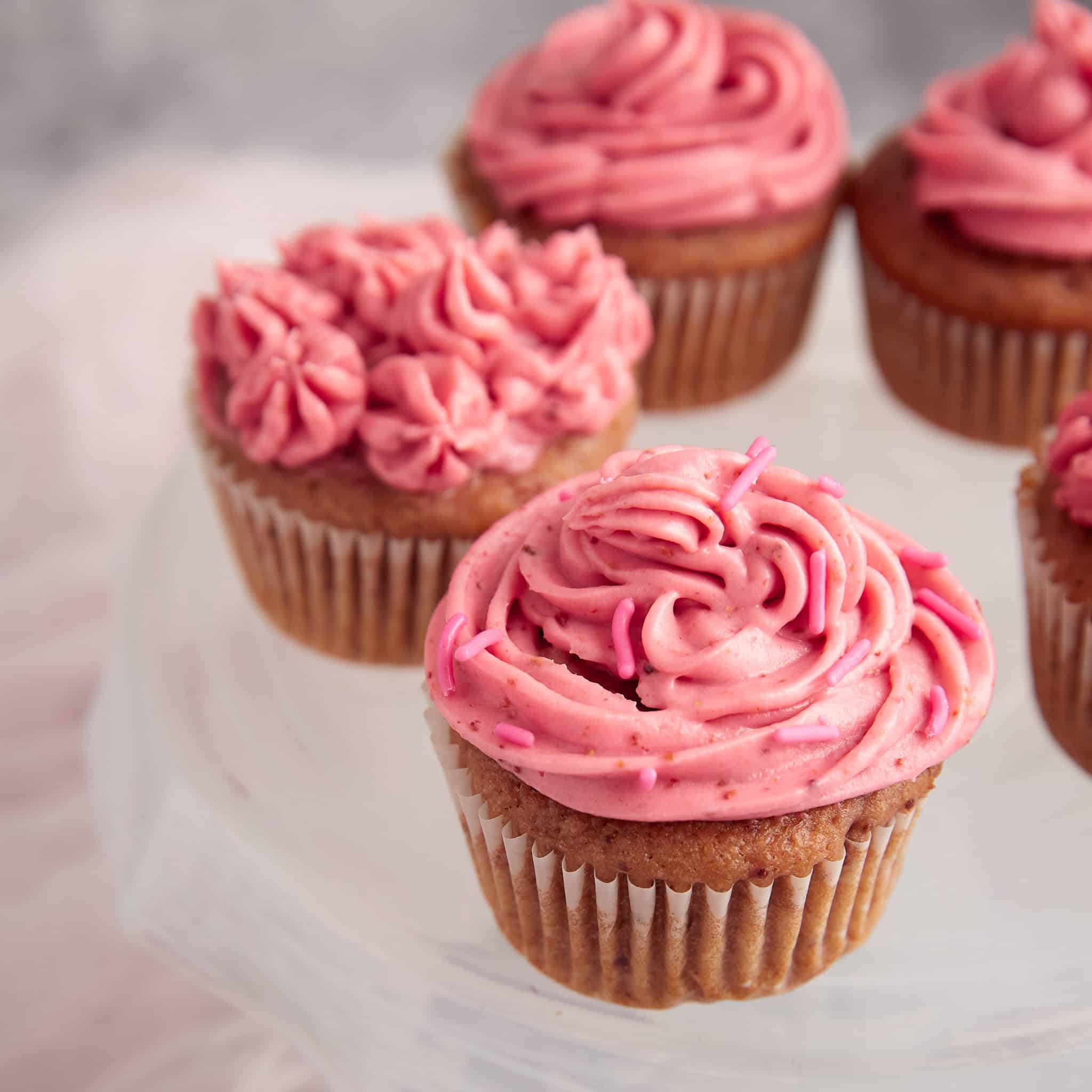 Strawberry cupcakes with cream cheese frosting.