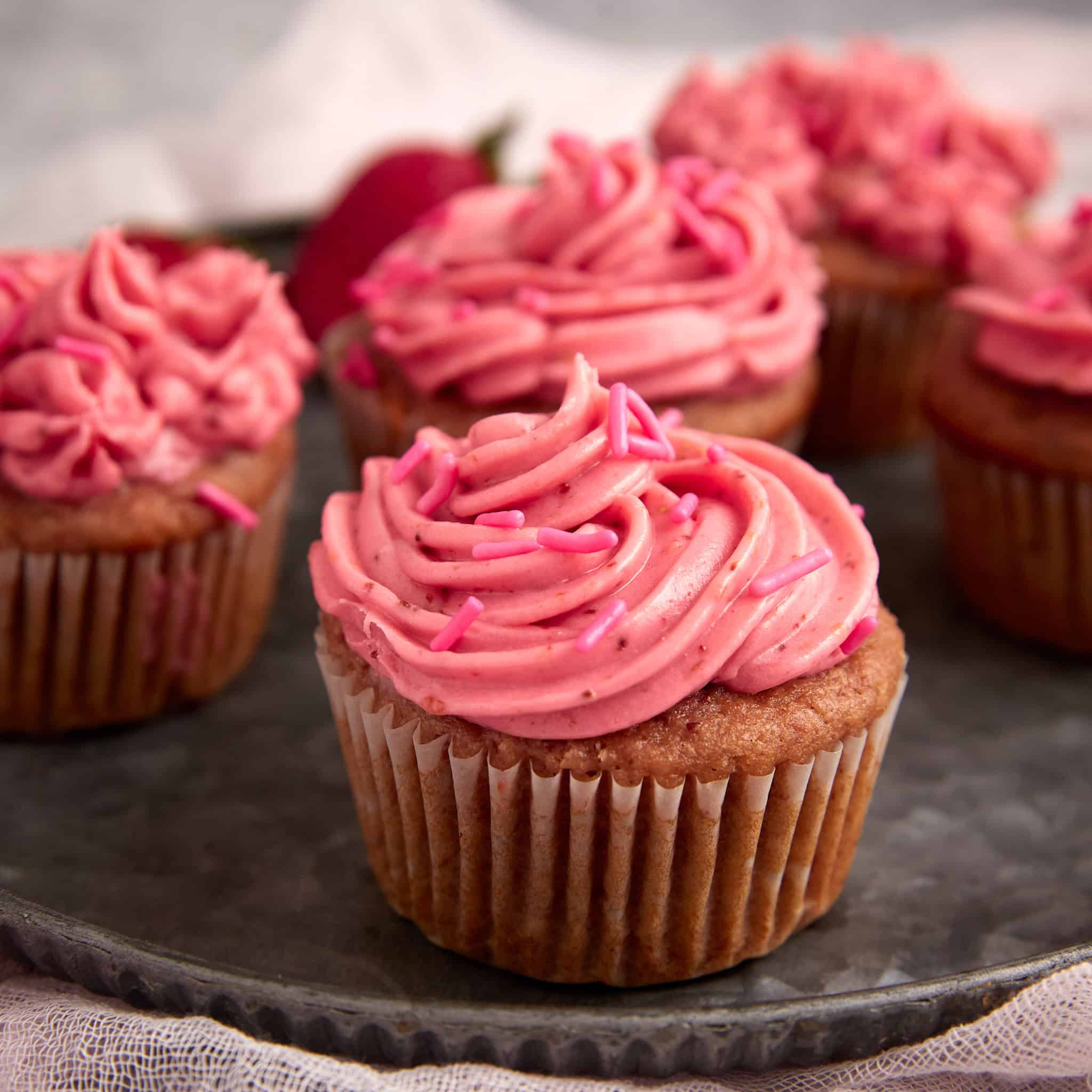 Strawberry cream cheese frosting on a cupcake.