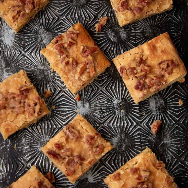 Caramel bars on a black serving platter.
