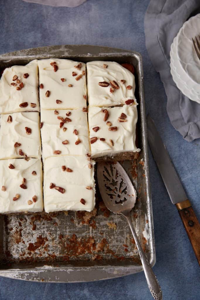 A hummingbird sheet cake cut into squares. 
