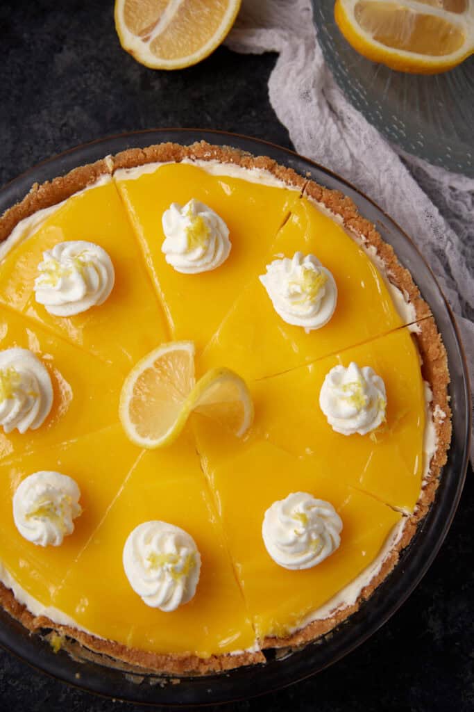 A lemon curd pie with a lemon twist on top.