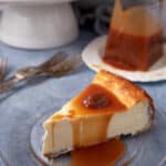 A single slice of cheesecake with caramel on top.