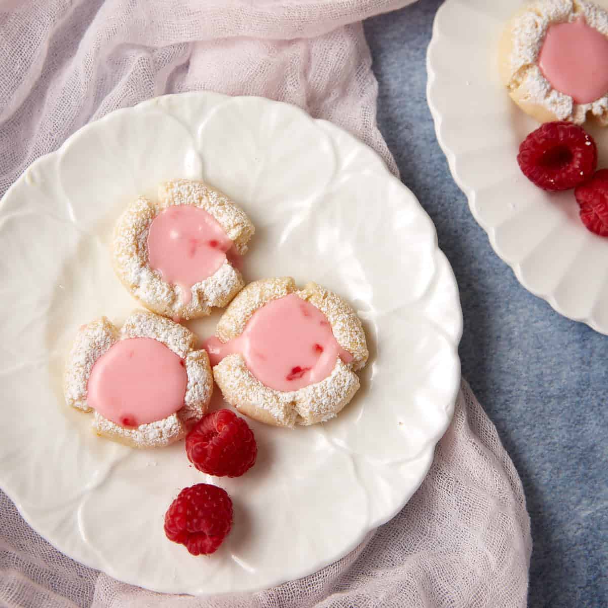 Three raspberry lemonade cookies on a plate.