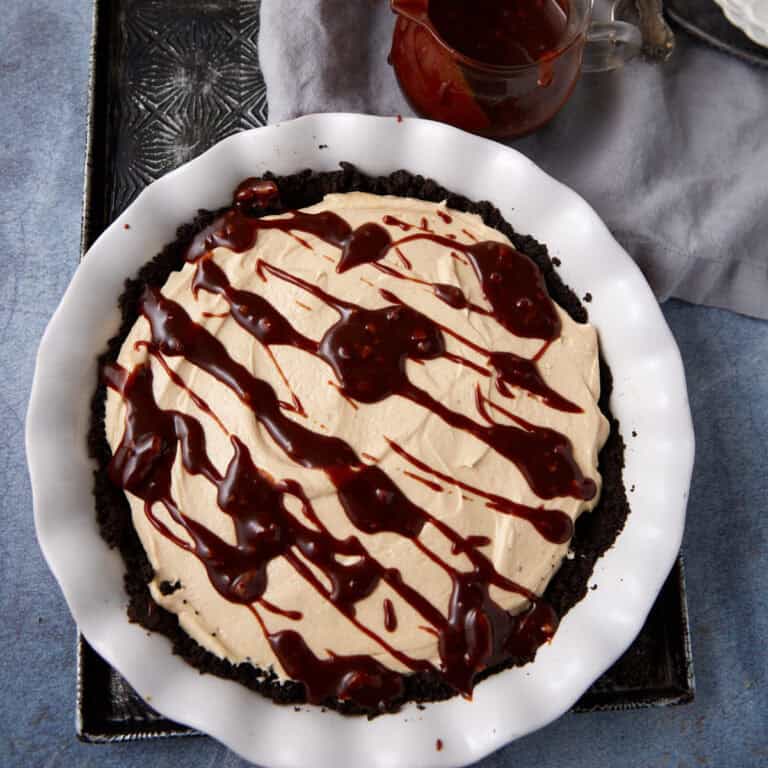 A turtle pie drizzled with chocolate caramel sauce.