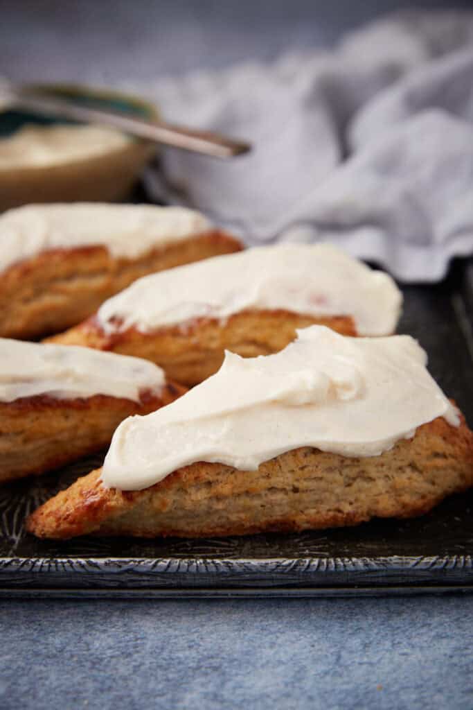 Frosted banana nut scones on a platter.