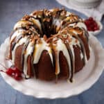 A banana split cake topped with frosting and syrups.