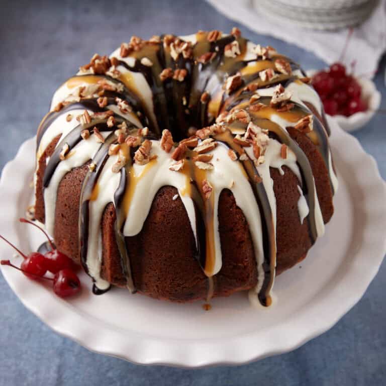 A banana split cake topped with frosting and syrups.