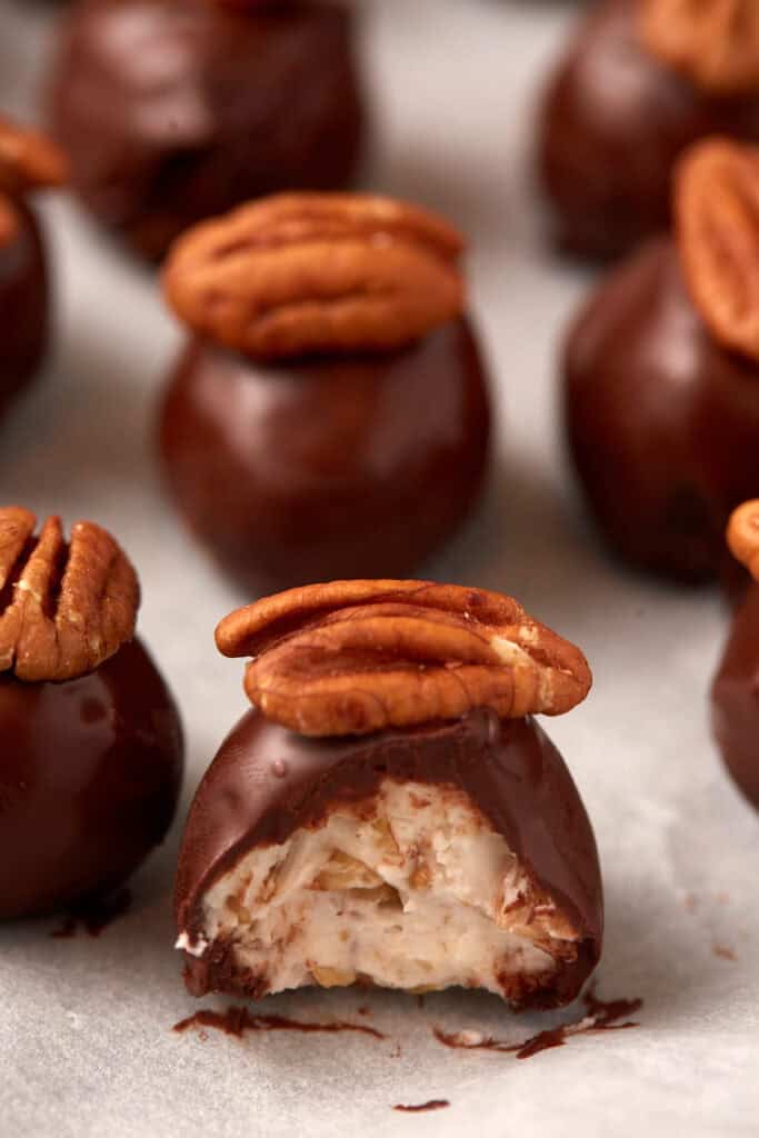 A bourbon ball with a bite taken out.