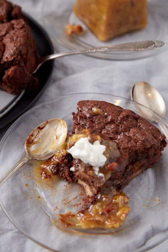 A slice of chocolate bread pudding with a bite taken.