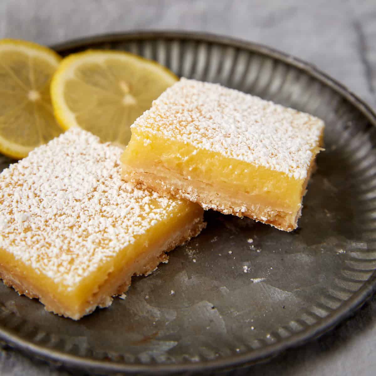 Lemon squares on a plate.