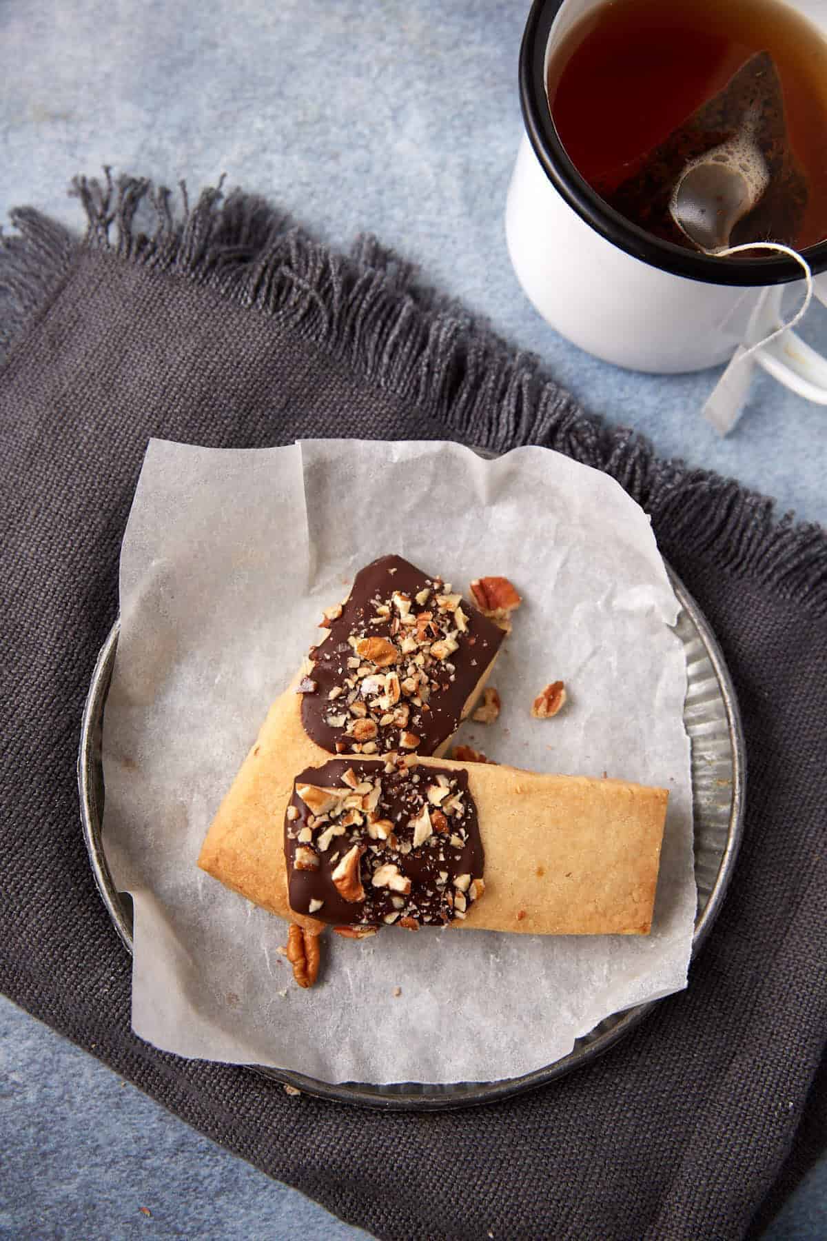 A dessert plate with two chocolate dipped shortbread cookies