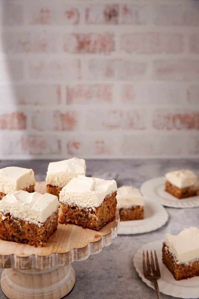 A cake platter with slices of carrot cake.