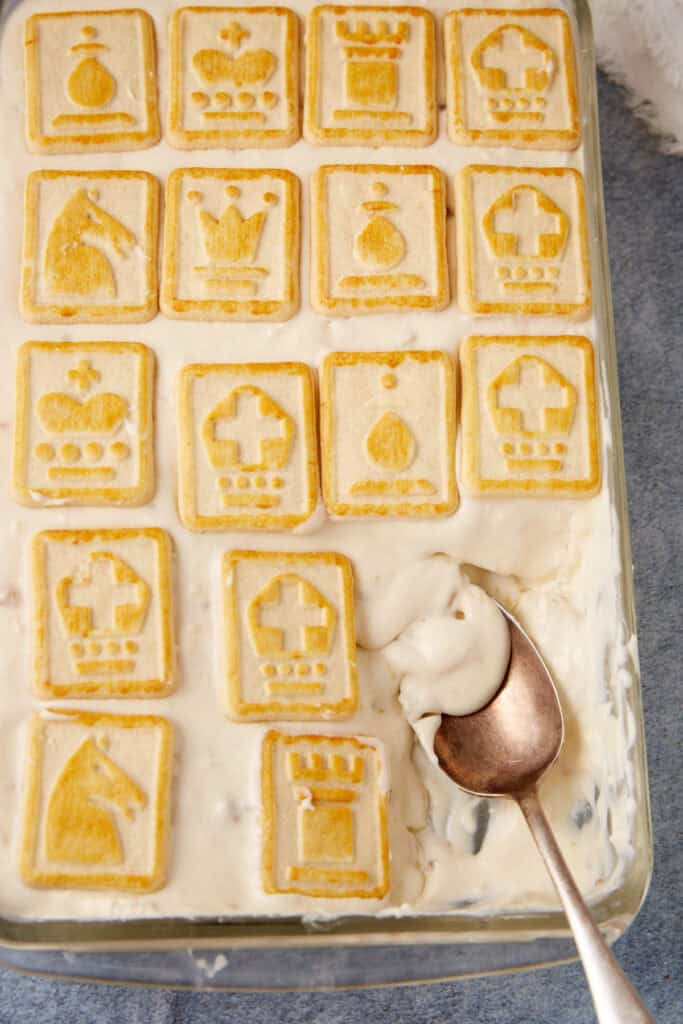 A dish of banana pudding with a serving spoon.