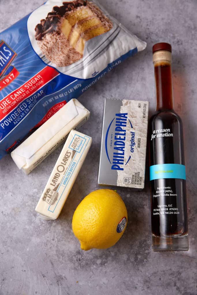 lemon cream cheese frosting ingredients on a gray background.