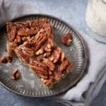 pecan pie bars on a gray plate.